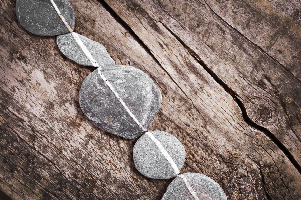 Stones aligned on wood